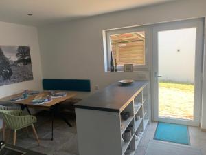 a kitchen with a table and a table and a window at Draußen am See in Losheim