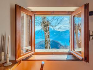 a window with a view of a mountain at Chalet Baita Santina by Interhome in Peglio