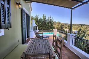 a porch with a wooden bench on a balcony at Villa Ostria in Tsoukalades