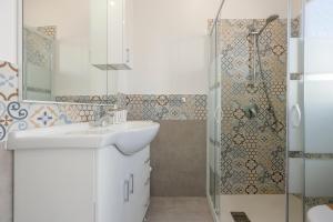 a bathroom with a sink and a shower at La Terrazza Di Porticello in Porticello +26 photos