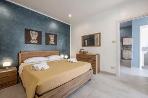 a bedroom with a large bed with towels on it at La Terrazza Di Porticello in Porticello