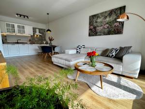 a living room with a couch and a table at PROMENADA Apartments with FREE PARKING in Nitra +27 photos