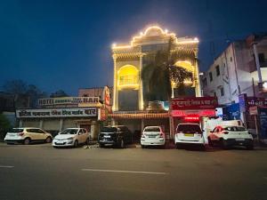 a group of cars parked in front of a building at Hotel Shiv-Shakti in Solapur