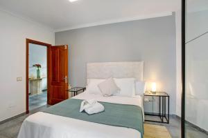 a bedroom with a bed with two white shoes on it at Carmelo y Carmela 3 in Teror