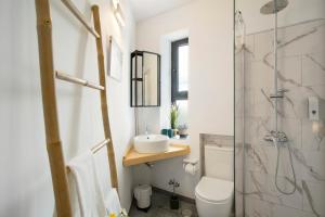 a bathroom with a sink and a toilet and a shower at Carmelo y Carmela 3 in Teror +21 photos