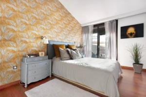 a bedroom with a bed with a dresser and a window at Villa Horizonte in Santa Úrsula +37 photos