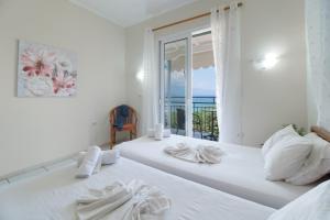a bedroom with two beds with a view of the ocean at S7 apartment in Nikiana