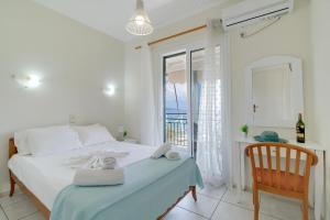 a bedroom with a bed with a chair and a window at S7 apartment in Nikiana +15 photos