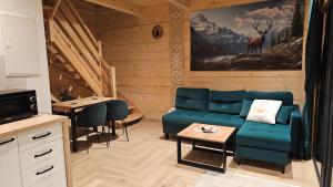 a living room with a couch and a table at Domki góralskie Cisza Leśna in Czerwienne