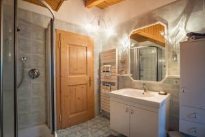 a bathroom with a sink and a shower and a mirror at Adulty Only Wasserfall Tschorn in Fundres