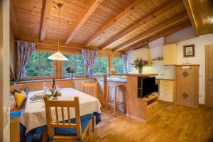 a kitchen and dining room with a table in a room at Adulty Only Wasserfall Tschorn in Fundres +9 photos