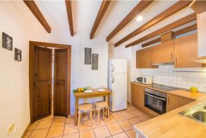 a kitchen with a table and some chairs in it at Ca Na Magda in Port de Soller