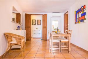 a kitchen and dining room with a table and chairs at Ca Na Magda in Port de Soller +10 photos