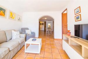 a living room with a couch and a tv at Ca Na Magda in Port de Soller