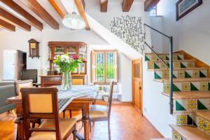 a dining room with a table and chairs and a staircase at Ca'n Repic in Port de Soller