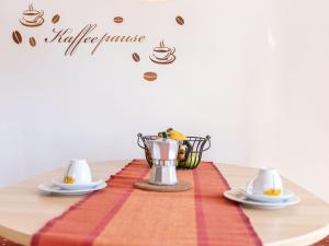 a table with two cups and a coffee maker on it at Holiday Home Orbani by Interhome in Lovran +54 photos