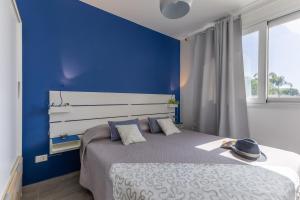 a blue bedroom with a bed with a blue wall at Villa Heraia con piscina in Marina di Ragusa +41 photos