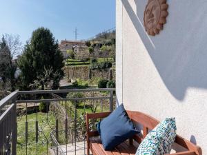 a balcony with a blue pillow and a chair at Holiday Home Orbani by Interhome in Lovran