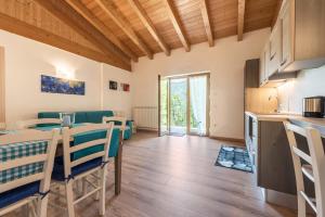 a kitchen and dining room with a table and chairs at Nonno Bigi Genziana in Tremosine Sul Garda