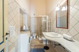 a bathroom with a sink and a toilet at Le Residenze In Piazza in Bosa +56 photos