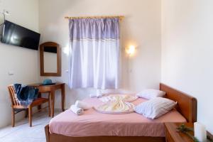 a bedroom with a bed with a plate of food on it at Nikiana Club - Studio 2 in Nikiana