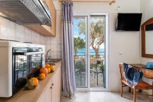 a kitchen with a view of the ocean at Nikiana Club - Studio 2 in Nikiana