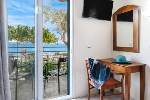 a room with a desk and a view of the ocean at Nikiana Club - Studio 2 in Nikiana +14 photos