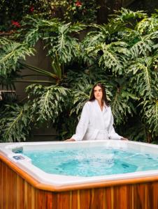a woman sitting in a bath tub at Hotel Boutique Casa Alebrije in Mexico City