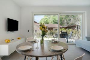 a living room with a table and a large window at Haus Weinblick Apt 3 in Magrè allʼ Adige