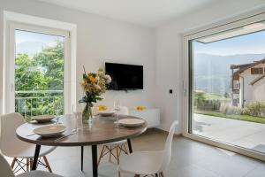 a dining room with a table and a large window at Haus Weinblick Apt 3 in Magrè allʼ Adige