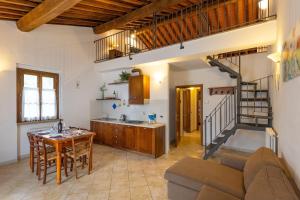 a kitchen and living room with a couch and a table at Borgo San Carlo in Santa Luce