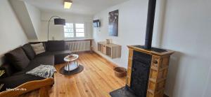 a living room with a wood stove in it at Ferienwohnung Hofidylle in Münstertal