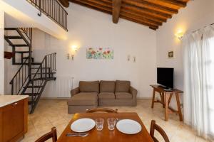a living room with a table and a couch at Borgo San Carlo in Santa Luce