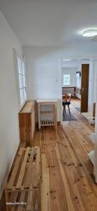 a room with a wooden floor and a table in it at Ferienwohnung Hofidylle in Münstertal