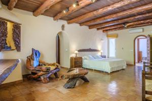 a bedroom with a bed and a chair in a room at Shangri-la in Santa Eularia des Riu