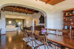a kitchen and dining room with a wooden table and chairs at Shangri-la in Santa Eularia des Riu