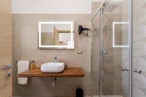 a bathroom with a sink and a shower at Le scuderie 9 in Galatone +22 photos