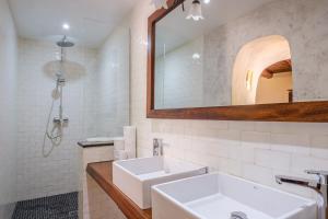 a white bathroom with a sink and a mirror at Shangri-la in Santa Eularia des Riu +24 photos