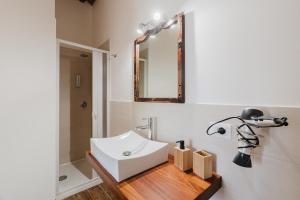 a bathroom with a white sink and a mirror at Siciliantica - Rilievo in Rilievo +74 photos