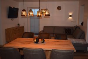 a living room with a wooden table and chairs at Ferienhaus Hanni in Geeste