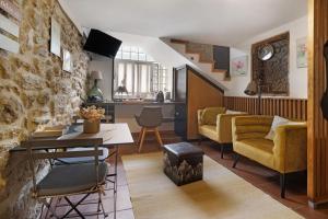 a kitchen and living room with a stone wall at Quinta Da Cevidade in Melgaço