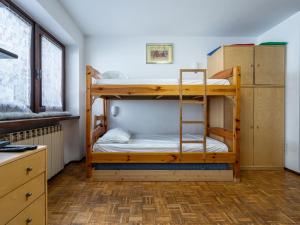 two bunk beds in a room with a desk at Apartment Richardette by Interhome in Sauze d'Oulx