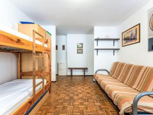 a room with two bunk beds and a couch at Apartment Richardette by Interhome in Sauze d'Oulx