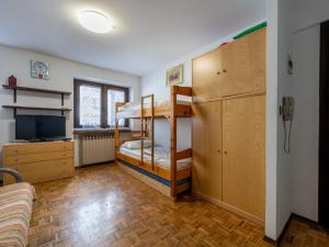 a room with two bunk beds and a television at Apartment Richardette by Interhome in Sauze d'Oulx +21 photos