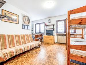 a living room with a couch and a bunk bed at Apartment Richardette by Interhome in Sauze d'Oulx