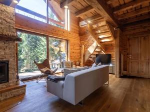 a living room with a couch and a fireplace at Chalet Hidden Heaven by Interhome in Sunger