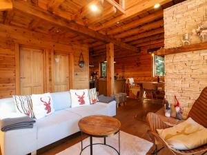 a living room with a white couch and a table at Chalet Hidden Heaven by Interhome in Sunger