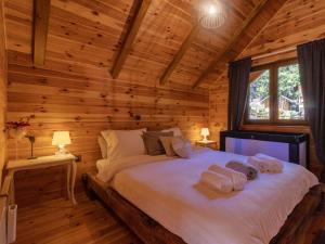 a bedroom with a bed in a log cabin at Chalet Hidden Heaven by Interhome in Sunger