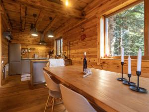 a wooden cabin with a long wooden table with candles at Chalet Hidden Heaven by Interhome in Sunger +11 photos