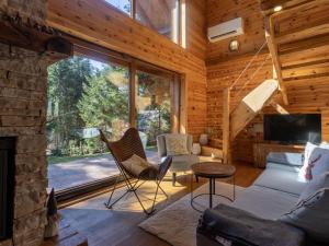 a living room with a couch and a fireplace at Chalet Hidden Heaven by Interhome in Sunger
